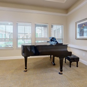 Settle into comfort at The Auberge at Cedar Park a piano in a room