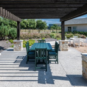 A covered patio with outdoor furniture