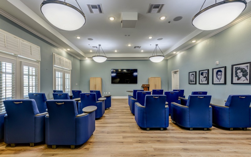 Movie theater with large screen and chairs