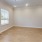 a room with a wood floor and windows