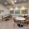 a room with a table chairs and a painting on the wall