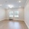a room with a wood floor and white walls