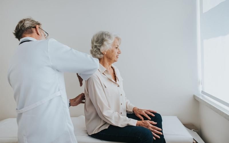 a doctor checking on an older woman