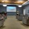 a room with a large screen and chairs