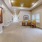 a long hallway with chairs and a table